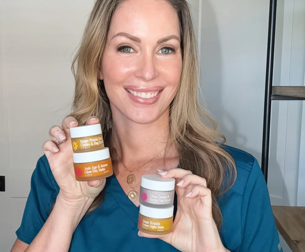 Dr. Becky Campbell holding the four Frøya balms